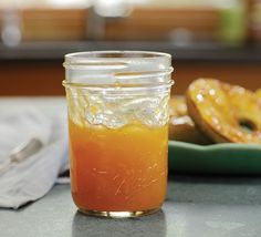 a glass jar filled with liquid sitting on top of a table