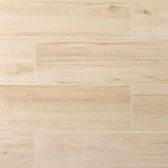 a white tile floor with light brown wood grains