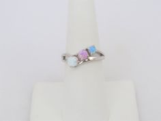 Vintage Sterling Silver White, Blue, Pink Opal Three stone Ring ...Marked 925...Total of weights 2.7grams...Size 7...Measure of Face 6.5MM...It's in very good condition. A#01 791 Sterling Silver Round Opal Ring, Sterling Silver Three Stone Round Gemstones, Adjustable Multi-stone Opal Ring For Anniversary, Classic Silver Opal Ring With Multi-stone, Round Sterling Silver Three-stone Gemstones, Multi-stone Opal Ring In 14k White Gold, Sterling Silver Opal Ring With Multi-stone Design, Sterling Silver Multi-stone Opal Ring, Oval Multi-stone Opal Ring In Sterling Silver