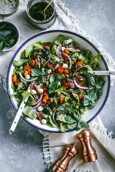 a salad with carrots, onions and spinach in a bowl