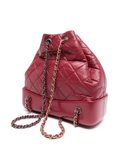 The Gabrielle model is inspired by the legendary love story between iconic designer Coco Chanel and Arthur Boy Capel. This limited-edition product represents the class and elegance of eternal love. The bag depicts Coco Chanel and her lover united in an embrace with the intent to exchange a kiss. Expertly crafted with red leather and diamond quilting, accented with the signature interlocking CC logo, this backpack effortlessly blends style and functionality Red Leather Diamond quilting Signature Luxury Leather Backpack With Removable Pouch, Red Backpack With Removable Pouch, Evening Leather Backpack With Detachable Strap, Chic Red Backpack Bag, Leather Backpack For Evening, Luxury Leather Evening Backpack, Luxury Red Backpack Bags, Luxury Red Backpack, Luxury Red Bucket Shoulder Bag