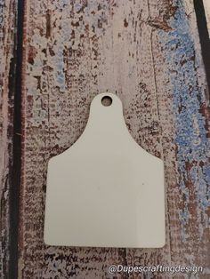 a piece of white paint sitting on top of a wooden floor