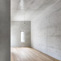 an empty room with white walls and wooden floors is seen in this image from the inside