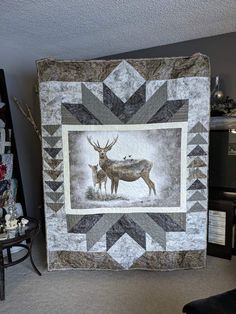 a quilt with an image of two deer on it