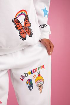 This is a Pre-Order, item will ship by 11/25 Mayfair x ISCREAMCOLOUR collaboration White doodle sweatpants 100% Cotton Image 1: Model is 5'8" and wearing size S/M Turn inside out and machine wash cold with like colors Playful Cotton Joggers For Loungewear, Playful Relaxed Fit Sweatpants For Loungewear, Playful Sweatpants With Elastic Waistband For Loungewear, White Sporty Sweatpants With Graphic Print, Sporty White Sweatpants With Graphic Print, Trendy White Winter Sweatpants, Trendy White Sweatpants For Winter, White Graphic Print Sweats For Loungewear, White Playful Relaxed Fit Bottoms