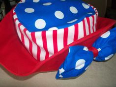 a red, white and blue hat with polka dots on it sitting on top of a table