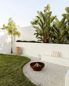 an outdoor fire pit in the middle of a yard