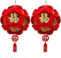 two red and gold paper decorations with chinese writing on the top, one in the shape of a flower