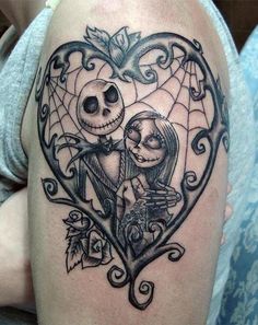 a couple in a heart shaped frame tattoo on the arm, with an image of jack and