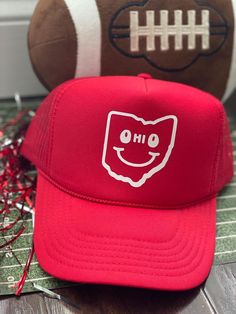 a red hat sitting on top of a table next to a football