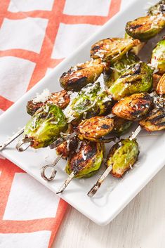 grilled brussel sprouts with parmesan cheese on a white plate