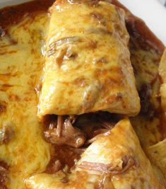 some food that is in a white bowl on a table and it looks like they are stuffed with meat