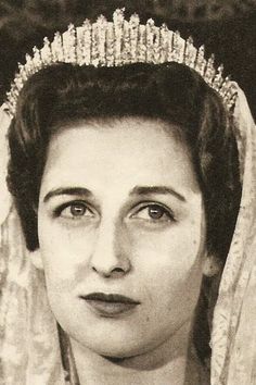 an old black and white photo of a woman wearing a tiara