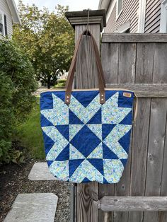 Flying Star Block Quilted Tote Bags with genuine leather handles and a zipper top to hold all your items safe and sound. Both bags have an interior zipper pocket for your valuables and some slip pockets to keep you organized.  Blue Bag :  The star is made of Liberty of London fabric and the dark blue is a Carolyn Feidlander fabric.  Lined with a neutra fabric. Approximate dimensions are: width accross the top - 18" height - 17" depth - 7" Maroon Bag:   SOLD    Super cute green and pink calico print is used for the star. It is lined with a green fabric. Appoximate dimensions are: width accross the top - 17" height - 14" depth - 5.5" Maroon Bag, Calico Print, Liberty Of London Fabric, Quilted Tote Bags, Star Blocks, Quilted Totes, Liberty Of London, Zipper Top, Quilt Block