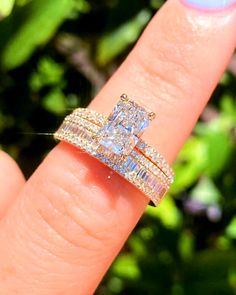 a woman's hand with two wedding rings on it