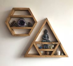 two wooden shelves with various items on them, one is shaped like a triangle and the other has a buddha statue