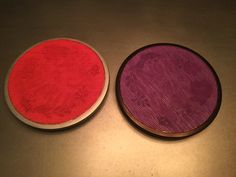 two red and purple circles sitting on top of a table