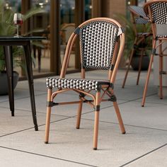 two chairs sitting next to each other on top of a tiled floor near tables and chairs