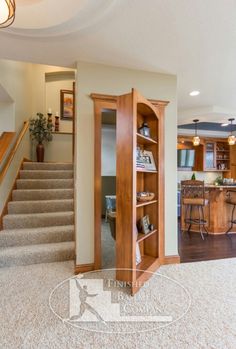 an open door leading to a kitchen and living room area with stairs in the background