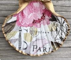 a paper plate with pink flowers on it and the word paris written in gold foil