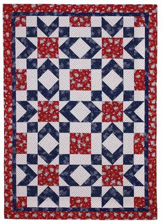 a red, white and blue quilt with an arrow design on the center is shown