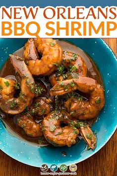 a blue plate topped with shrimp covered in sauce