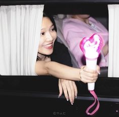 a woman is holding a hair dryer in her hand and smiling at the camera