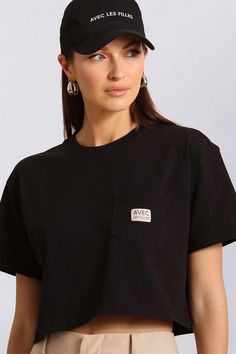 Core basics with an edge. Our Avec Les Filles logo tee features a relaxed, cropped fit, crew neck, chest pocket, and medium weight cotton for everyday comfort and versatility. Available in Black and White. Style #: 83568 Basic Everyday T-shirt With Pockets, Casual Black T-shirt With Logo Patch, Casual Summer Tops With Logo Patch, Relaxed Fit Logo Print Cropped T-shirt, Sporty Crew Neck T-shirt With Pockets, Casual Black Top With Logo Patch, Basic Cotton Cropped T-shirt For Streetwear, Sporty Crew Neck Tops With Pockets, Black Crew Neck Cropped T-shirt