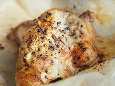 a piece of chicken sitting on top of white paper