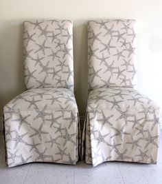 two white chairs with starfish print on them