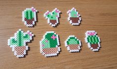 six pieces of perler bead art depicting cactuses and succulents