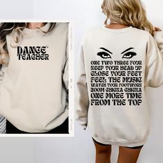 a woman wearing a sweatshirt with the words dance teacher on it and an image of her face