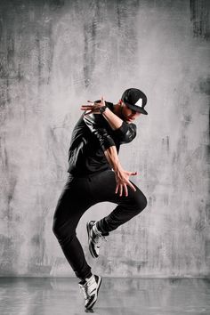 a man in black shirt and hat doing a trick