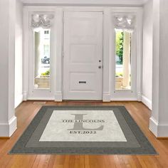 an empty room with white walls and wooden floors is shown in front of the door