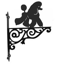 a black and white silhouette of a poodle on a wrought iron fence with an arrow