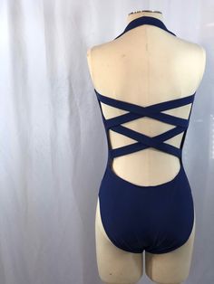 Vintage navy blue halter top swimsuit with high cuts for legs. Beautiful open back with criss cross straps. Built in shelf bra.  By Sun Streak  Size 10 Measurements when laying flat (unstretched): Underarm to underarm 13 1/2" Waist 12" Widest hip / top of leg hole 13 1/2" Crotch 4" Leg hole 9 1/2" high Top to bottom 26" Fitted Cross-tied T-back Swimwear, Strappy Stretch Swimwear With Tie Back, Cross-tied Backless Swimwear For Party, Backless Cross-tied Swimwear For Parties, Fitted Cross-tied Swimwear With Strappy Back, Cross-tied Backless Party Swimwear, Party Backless Cross-tied Swimwear, Party Cross-tied Backless Swimwear, Summer Backless Dancewear Leotard