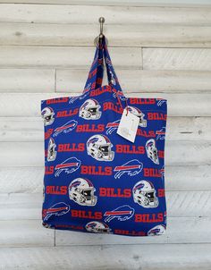 "Buffalo Bills Reusable Cloth Shopping/Market Tote Bag, Washable & Environmentally Friendly. Measuring 18.5\"x15.5\"x5\" this sturdy but supple flat-bottomed all-purpose bag has durable reinforced stitching on its handles - this is a bag built to last.  These bags are environmentally friendly, the perfect size to suit all your needs, lightweight yet sturdy enough to hold your shopping, latest craft project, or outdoor items. Conveniently foldable to fit in your backpack, purse or globe box. This Shopping Market, Market Tote Bag, Sports Bags Gym, Sports Gym, Market Tote, Gym Bags, Team Sports, Buffalo Bills, Shopping Tote Bag