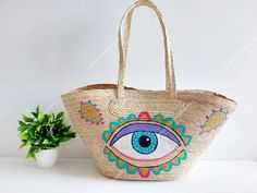 I love Mexico celebrates the native crafts of Mexico and the artists that produce them, enabling them and their communities to get recognized for their talented work and achieve economic stability for their families. This listing is for this bag shown on the picture, made of palm leaves and 100% natural materials. The paint is done by hand, and has a protective layer on top. The tassels or other accessories on the picture are not included. Measurements : please see pictures for exact size. All s Artisan Multicolor Straw Bag For Vacation, Bohemian Straw Bag For Shopping, Bohemian Straw Bag, Bohemian Handmade Straw Bag For Shopping, Handmade Bohemian Straw Bag For Shopping, Traditional Beach Bag For Summer, Artisan Multicolor Straw Bag For Summer, Bohemian Handmade Straw Shopping Bag, Artisan Beach Bag For Vacation