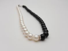 "This elegant and timeless pearl necklace is a must-have in a woman's wardrobe. It goes perfectly with almost anything It's a beautiful classic 18K white gold and real diamonds 8mm black and white pearl and black agate necklace The necklace length is 17.5\". It may be adjusted down to 17 inches. - created by exclusive Nimei brand designers Includes one 18K white gold and real high-quality diamond rondel The pearls are white, smooth and shiny with high luster 8x8.5 Chinese freshwater cultured pea Elegant Black Pearl Necklace For Weddings, Elegant Black Pearl Necklace, Elegant Black Pearl Necklace For Evening, Elegant Black Single Strand Pearl Necklace, Elegant Black Round Pearl Necklace, Classic Black Pearl Necklace For Formal Occasions, Classic Black Pearl Necklace For Formal Events, Black Agate Necklace, Black Agate