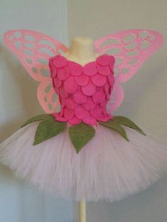 a pink and green fairy costume on a stick