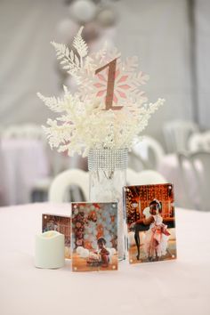 the table is set up with photos and flowers