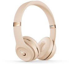 the beats by dr dre headphones are shown in light gold, with an extra bass