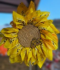 a sunflower with yellow petals and black spots