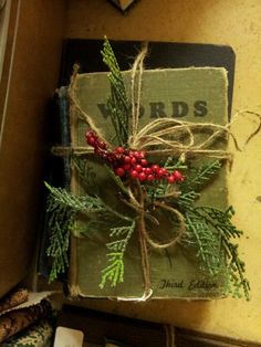 an old book with holly and berries tied to it