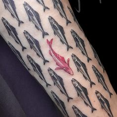 a person with a red fish tattoo on their arm