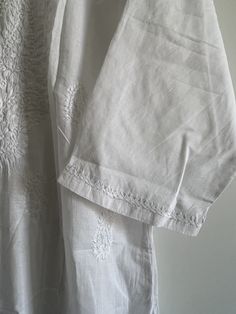 ☀️A personal favourite, get this classic piece for a timeless elegant yet casual look - hand embroidered white chikankari kurta in a pure soft cotton fabric. Light and airy, the most comfortable kurta you will ever own!    Hand made with a lot of love and attention to detail in the heart of India.    Pair it with linen pants for day out in the sun or white pyjamas for a perfect relaxed day at home.    Features embroidery on yoke, hem, back, and sleeves.    Delicate hand wash only.    NO RETURNS Elegant Off White Cotton Kurta, Classic White Kurta For Festive Occasions, Cotton Kurta With Floral Embroidery And Short Sleeve, Short Sleeve Cotton Kurta With Floral Embroidery, Classic Cotton Kurta For Wedding, Off White Straight Kurta For Summer, Classic Cotton Wedding Kurta, Summer Wedding Cotton Kurta, Elegant Cotton Kurta With Chikankari Embroidery