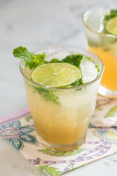 a tall glass filled with lemonade and mint