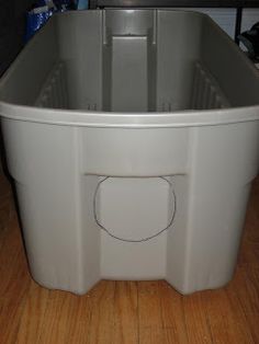 a white plastic container sitting on top of a wooden floor