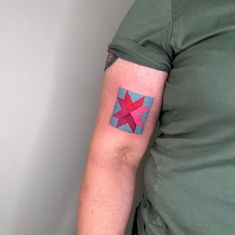 a person with a red star tattoo on their left arm and the other half of his arm