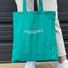 Get summer ready with this cute and trendy tote bag. Whether you are planning a beach day, sorority retreat, or bid day this bag is perfect! It’s lightweight material and unique personalized design will have you reaching for this bag all year long. This tote will have your sorority name embroidered in the thread color of your choice and the city and state will be embroidered white. Shown in light pink with medium pink thread, charcoal with black thread and Kelly green with blush pink thread. 6 o Summer School Canvas Gift Bag, Summer School Canvas Bag With Letter Print, Eco-friendly Summer School Canvas Bag, Bid Day Bags, Sorority Retreat, Sorority Names, Get Summer Ready, Pink Thread, Trendy Tote Bags